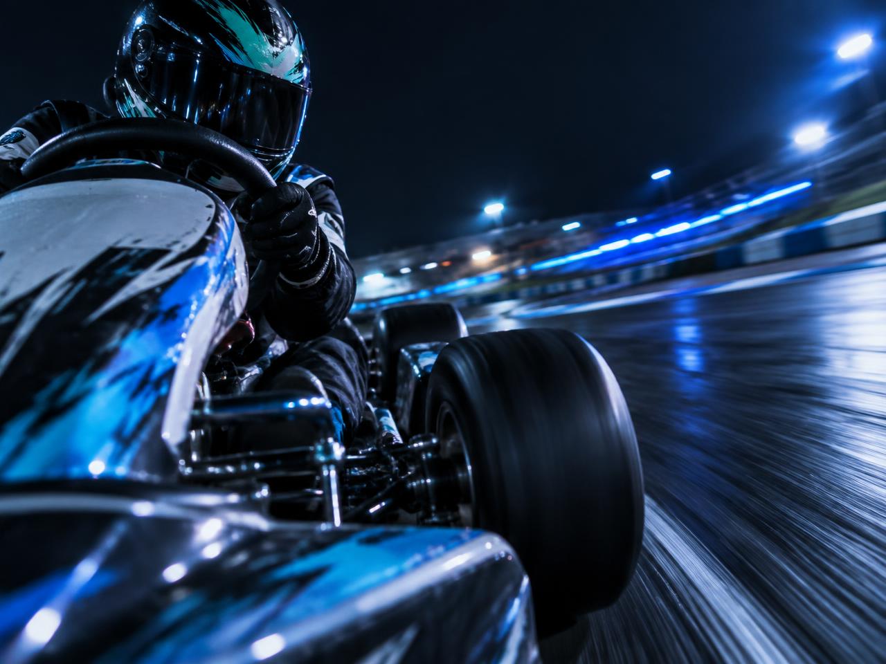 Luminous racing line curving through the night track